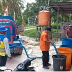 Petugas di lapangan saat mendistribusikan bantuan air bersih kepada masyarakat yang membutuhkan di Desa Sebakung Jaya, Kecamatan Babulu.